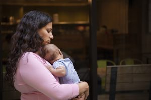 Mother holding her baby after overcoming PCOS infertility struggles
