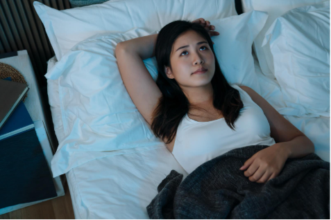 Woman with PCOS lying awake struggling with insomnia