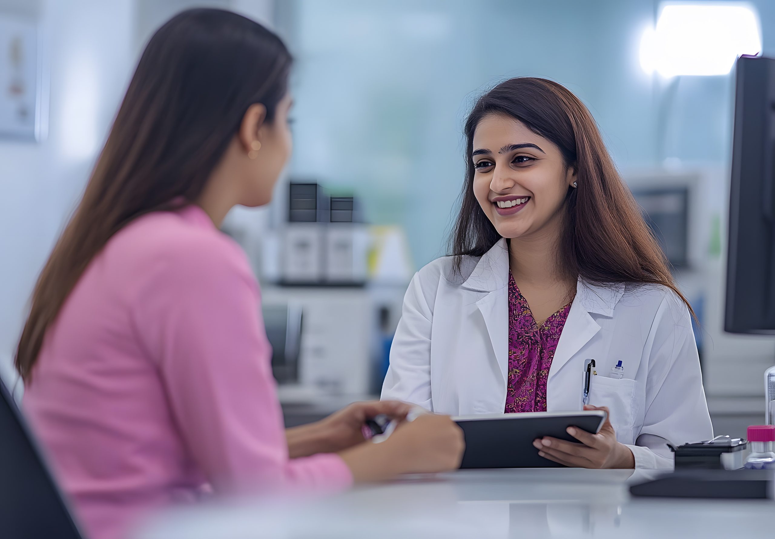 Indian female doctor discusses PCOS diagnosis, lab tests, and ultrasound criteria with a patient in clinic